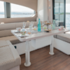 3-stage cylindrical anodised aluminium electric table lift NL2408 24V DC installed in yacht saloon, Ø200 mm deck plates, marine telescopic pedestal system