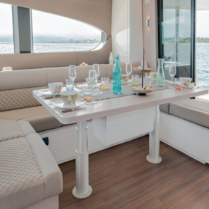 3-stage cylindrical anodised aluminium electric table lift NL2408 24V DC installed in yacht saloon, Ø200 mm deck plates, marine telescopic pedestal system
